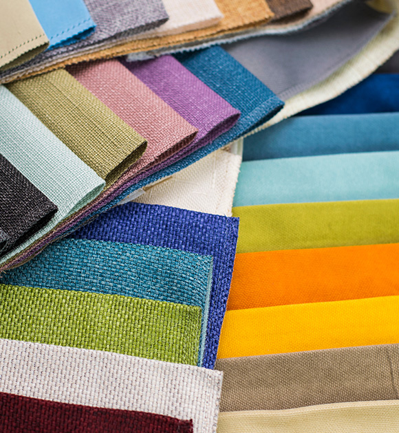A variety of fabric swatches in different colors for window blinds