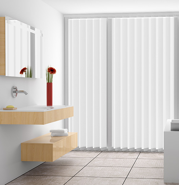 Vertical blinds installed in a modern bathroom setting with a wooden cabinet and flowers.