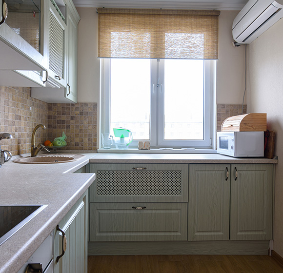 Woven roller blinds fitted above kitchen window doors in Livingston home