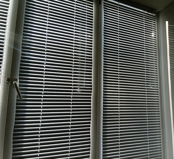 Vertical blinds with a light filtering effect on large windows.