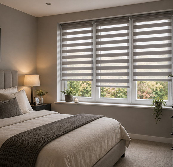 Modern bedroom featuring stylish day and night blinds on large windows.